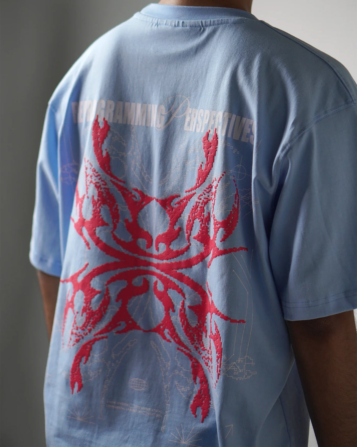 Light blue T-shirt back view with large red octopus-style graphic, crew neck short sleeves