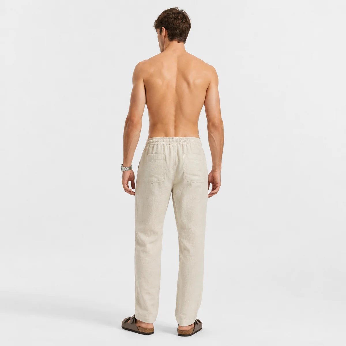 Sand beige linen pull-on pants shown from the back, elastic waistband with drawstring.