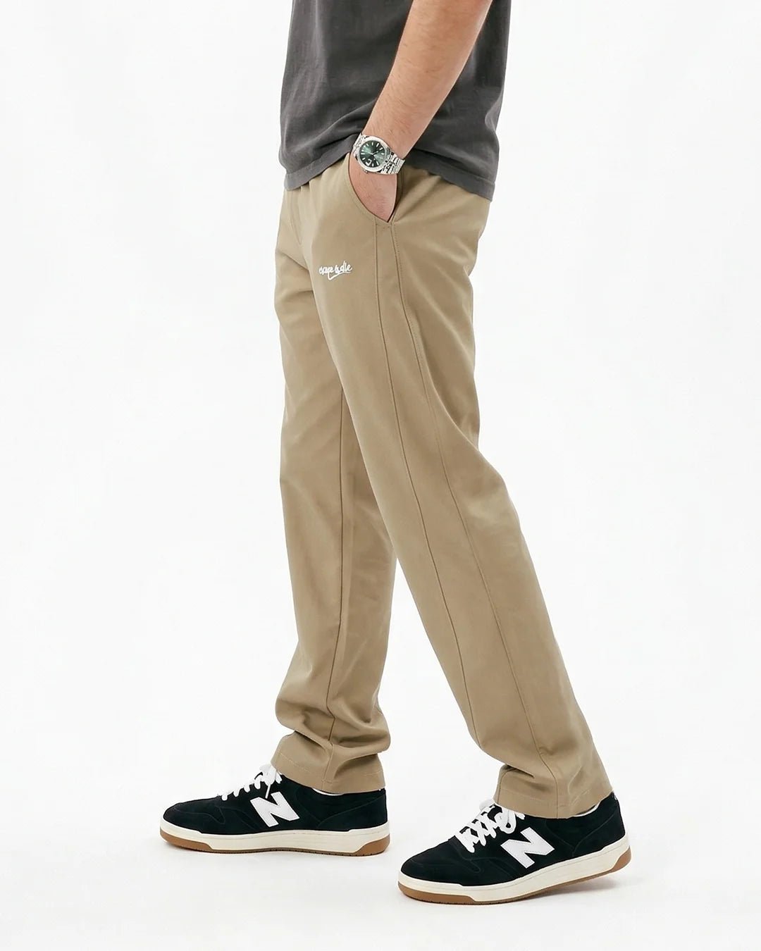 Beige Sand Motion sweatpants on model, side view, relaxed ankle-length hem