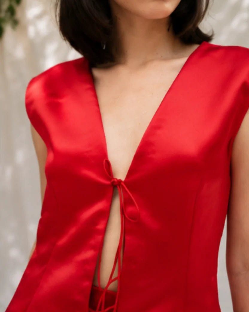 Red satin mini dress with V-neck and lace-up front cutout, sleeveless