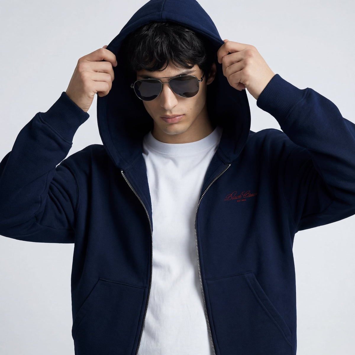 Navy zip-up hoodie with hood up, front zipper, kangaroo pocket opening
