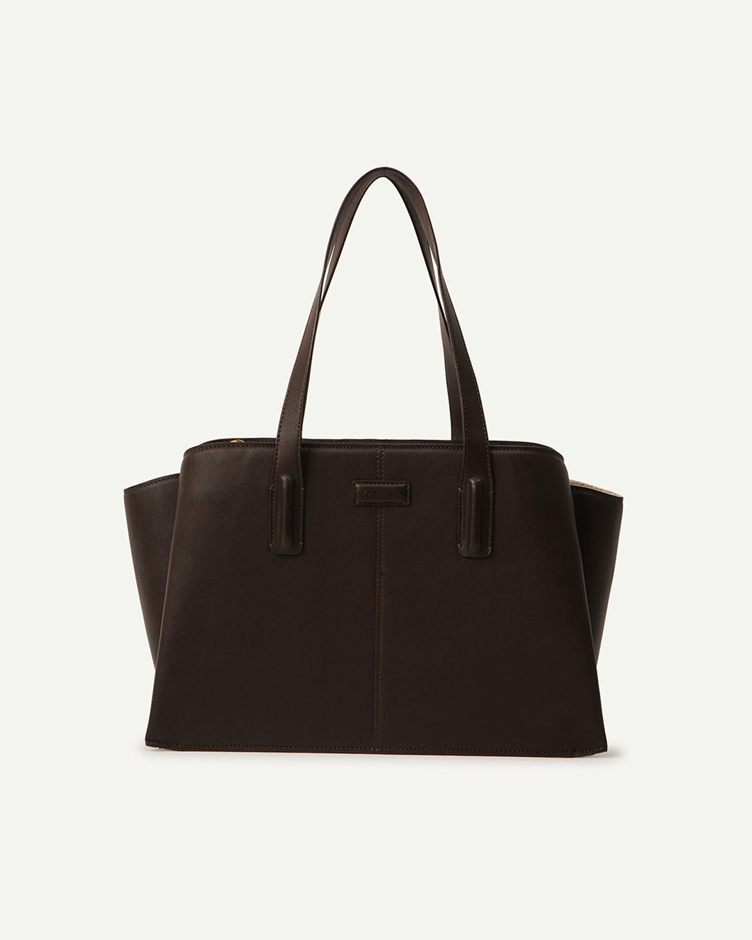 Dark brown leather tote bag on light background, center seam and top handles