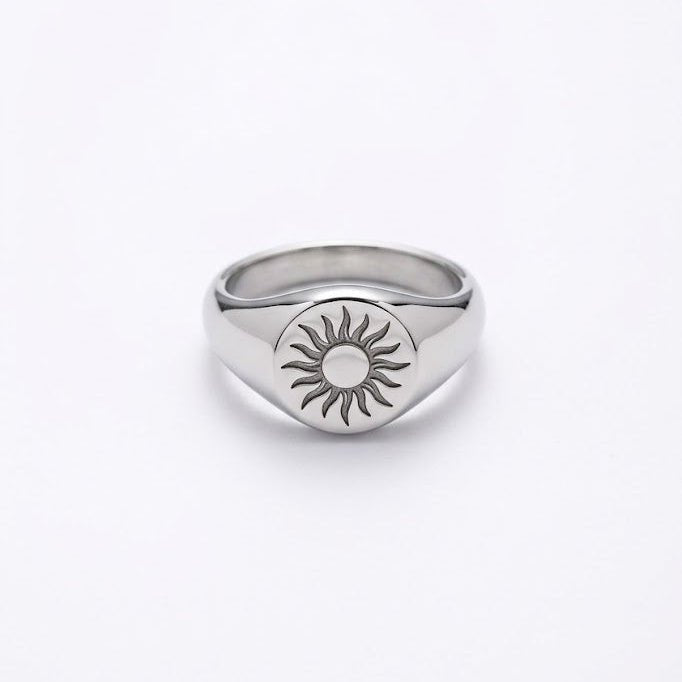 Silver-tone signet ring with sunburst engraving and round center detail