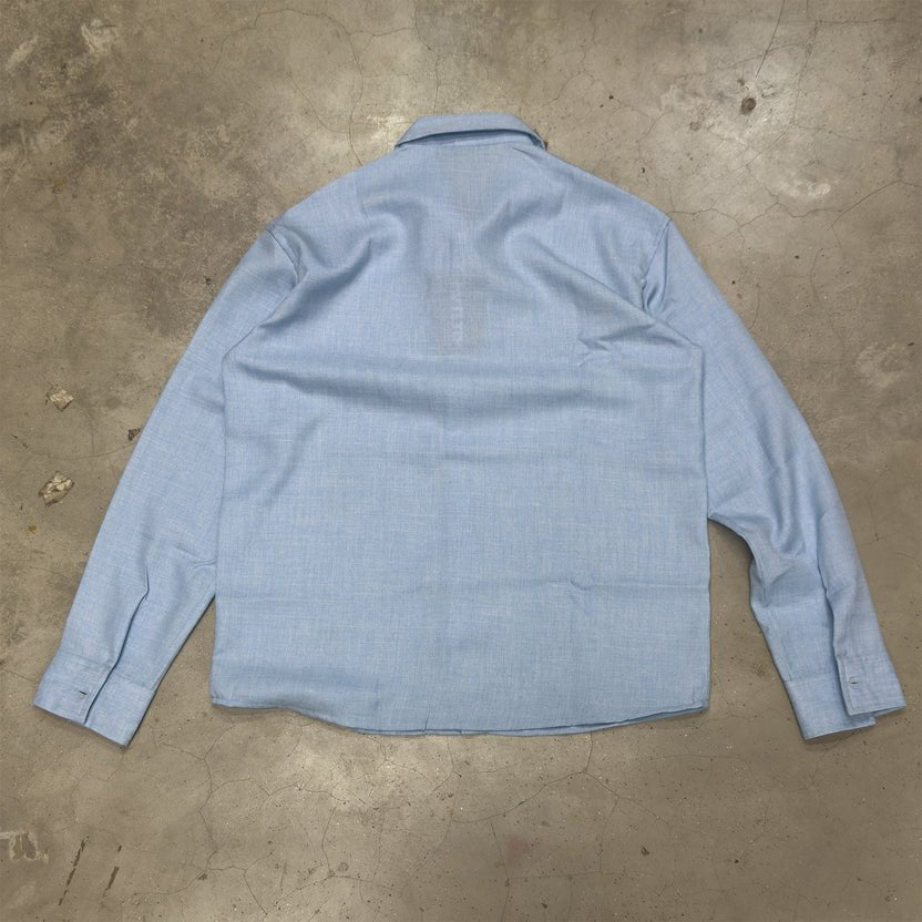 Sky blue linen shirt back view with point collar and long sleeves, slightly wrinkled