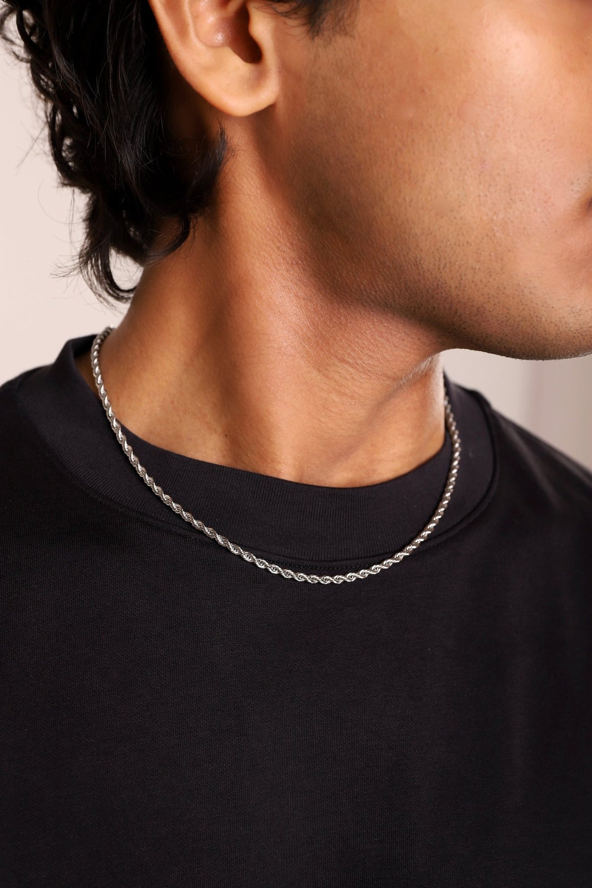 Rope chain necklace with twisted links, centered on the collarbone
