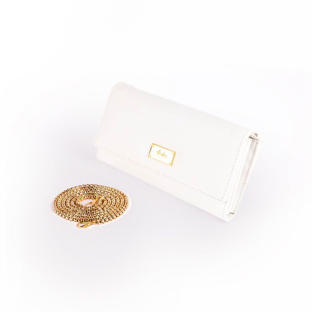 White clutch wallet with gold chain sling and front metal logo plate