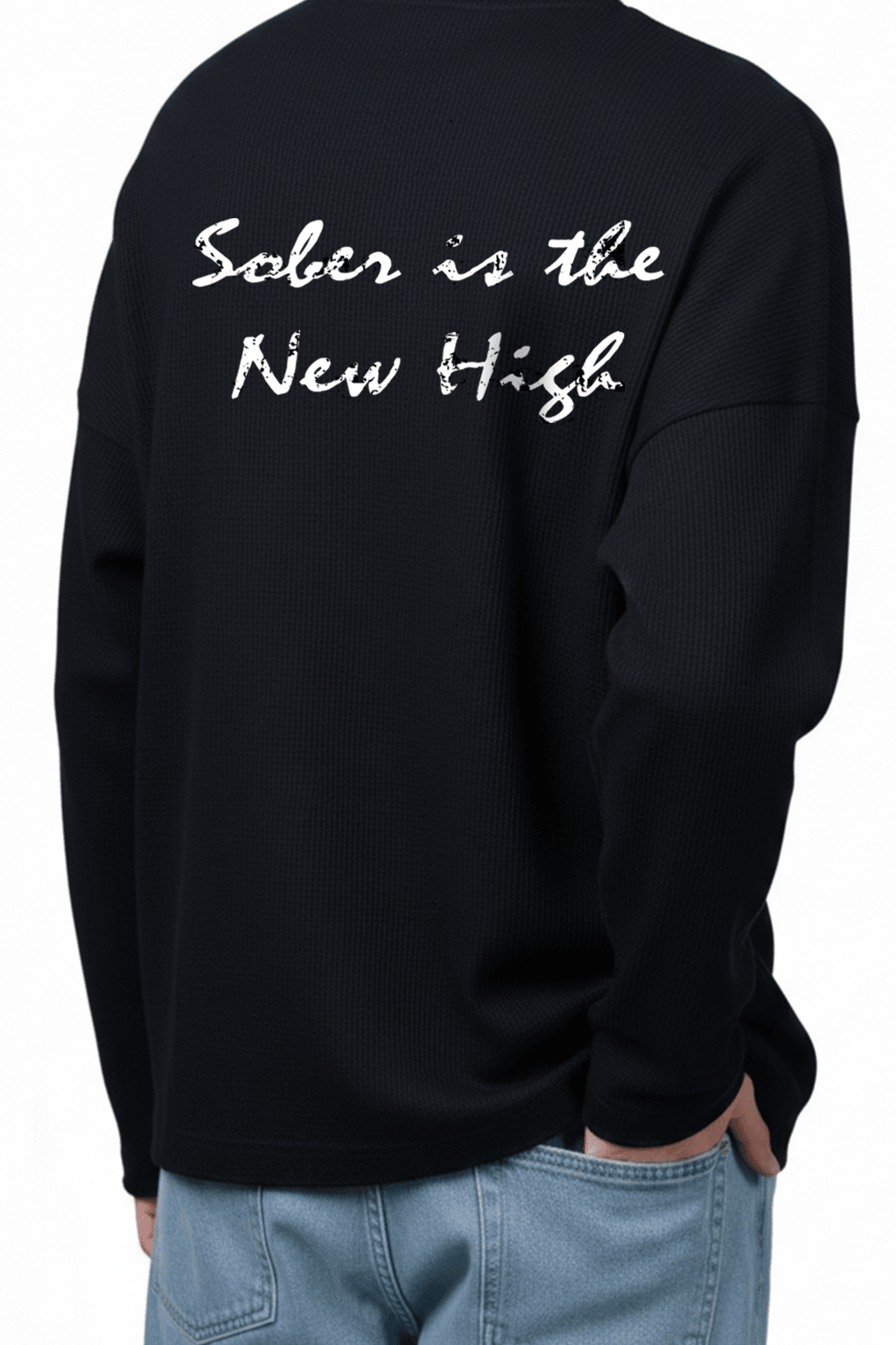 Black waffle-knit crewneck sweatshirt close-up of back graphic lettering.