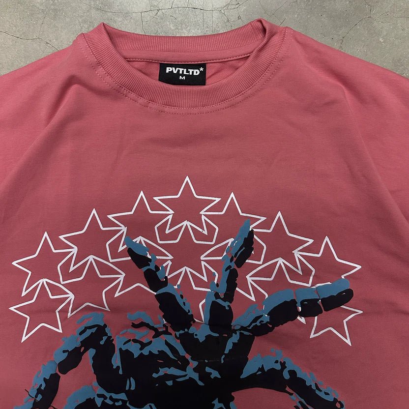 Maroon graphic T-shirt with starburst spider emblem in blue and black
