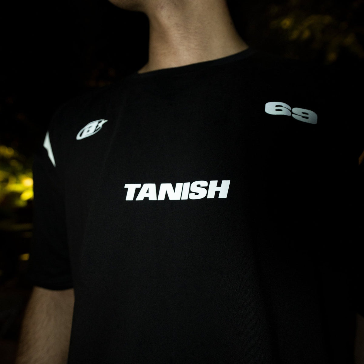 Black crewneck jersey shirt back close-up with TANISH print and 69 emblem