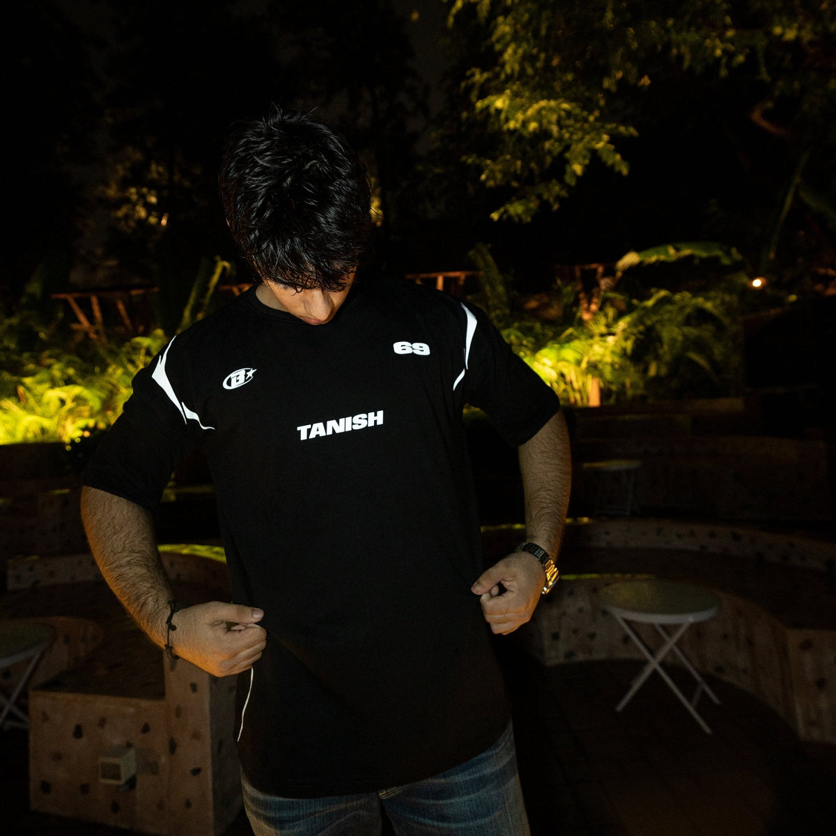 Black crewneck jersey shirt back view with TANISH logo and small side details