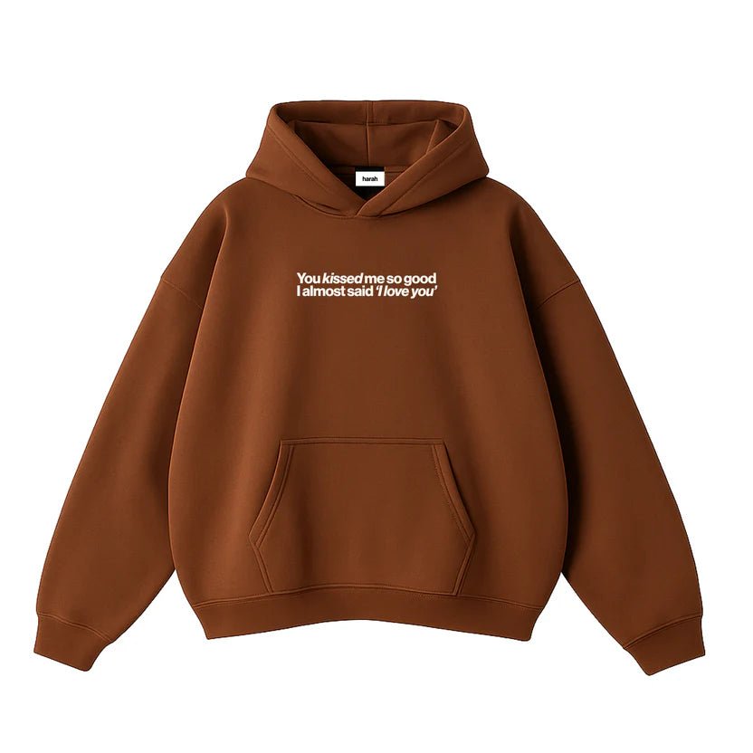Brown hoodie with front kangaroo pocket, drawstring hood, and small chest graphic print.