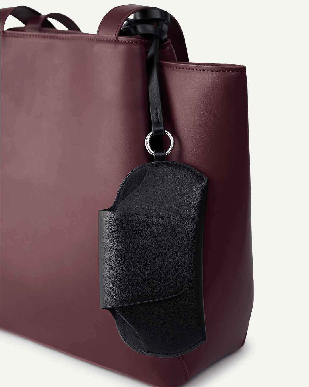 Black sunglass holder with curved flap and attached lanyard