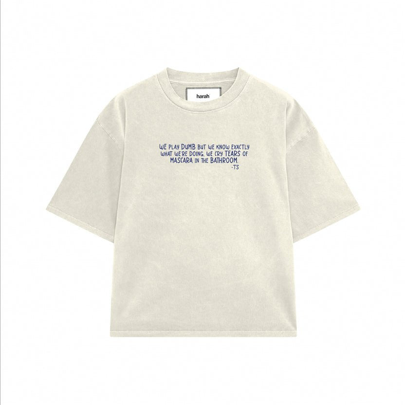 Light cream crew-neck graphic T-shirt with short sleeves and front text.