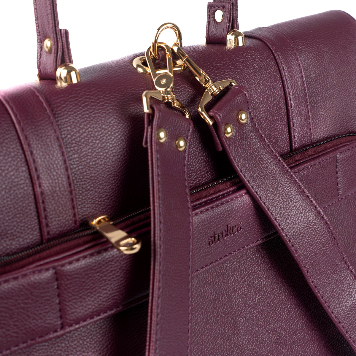 Burgundy bag front close-up with gold-tone latch hardware and zipper edge detail.