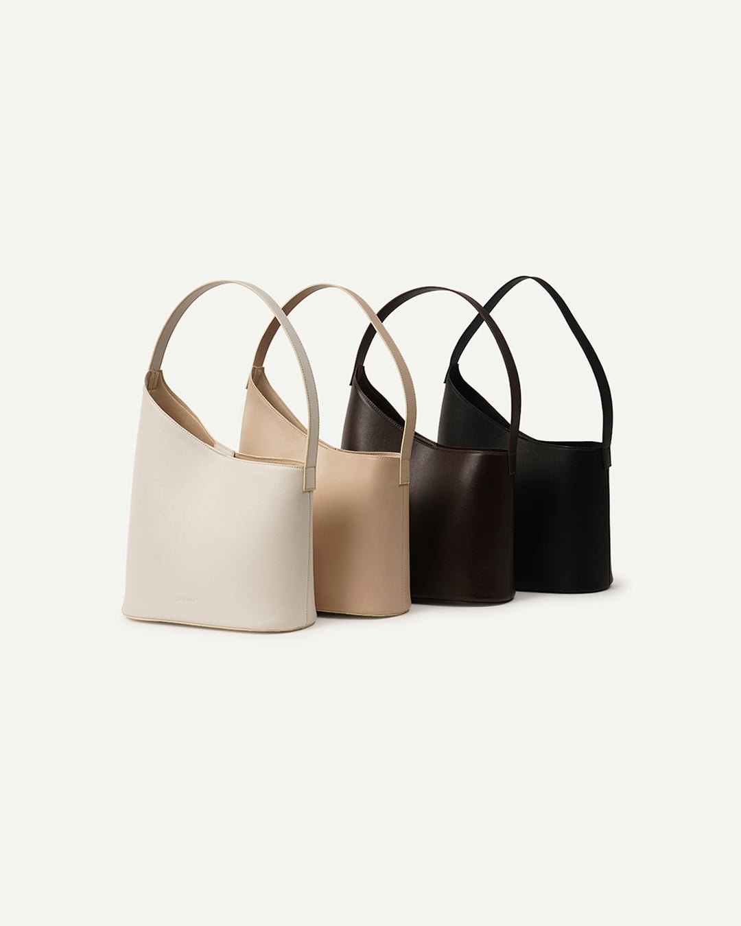 Set of bucket shoulder bags in black, tan, and beige with wide straps