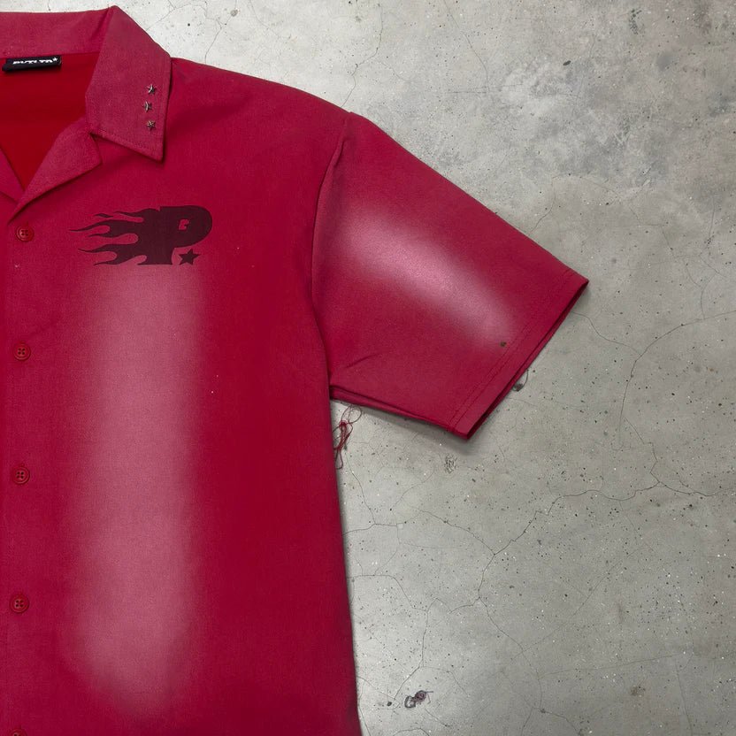 Red short-sleeve button-up shirt with point collar and front chest graphic