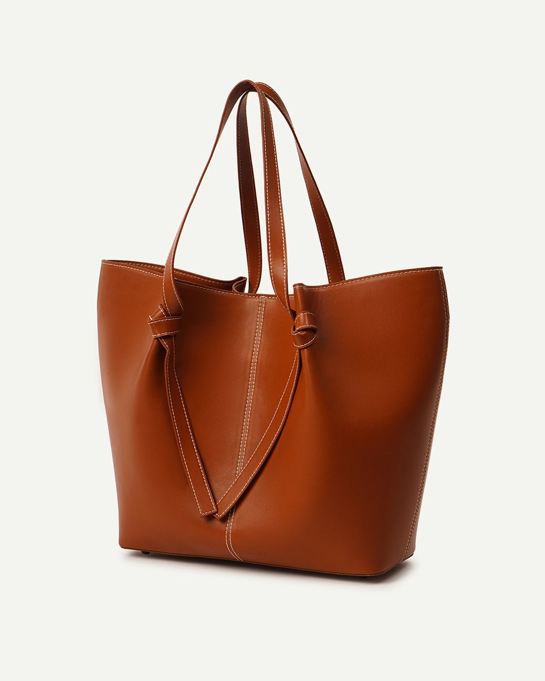 Tan leather tote bag with dual top handles and V-shaped front panel