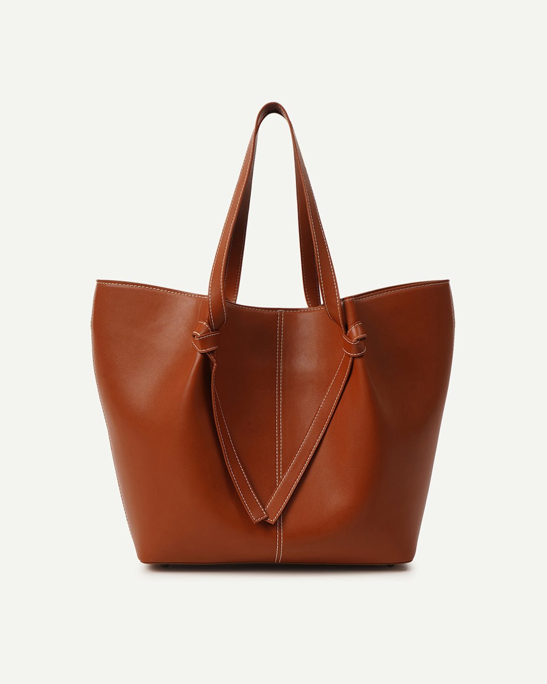 Tan leather tote bag with top handles and V-shaped front panel