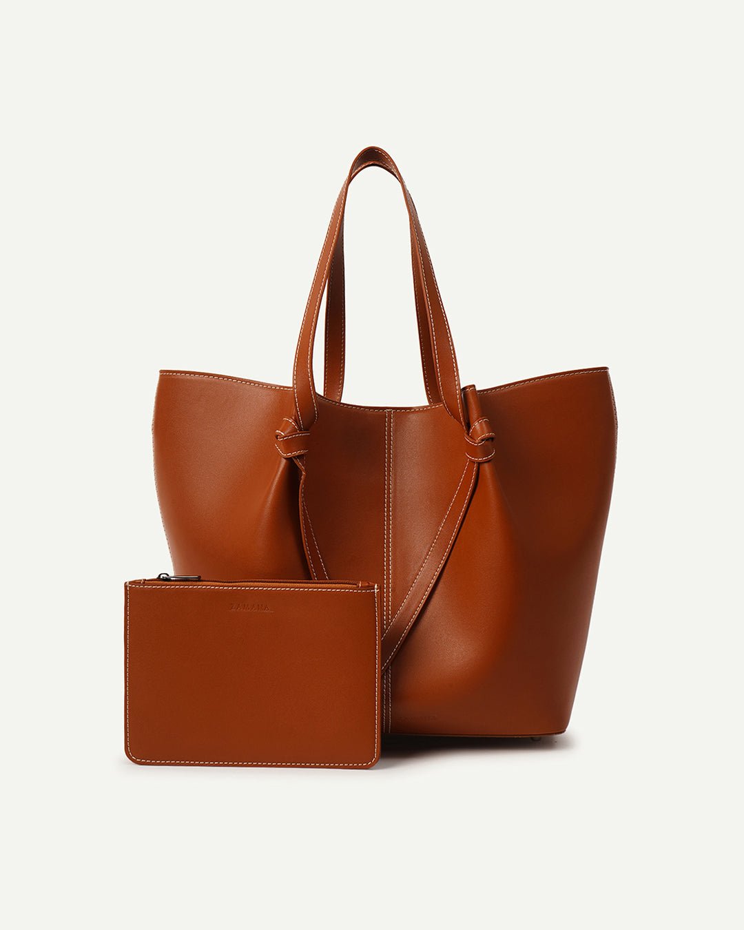 Tan leather tote bag with detachable zip pouch and V-shaped front panel