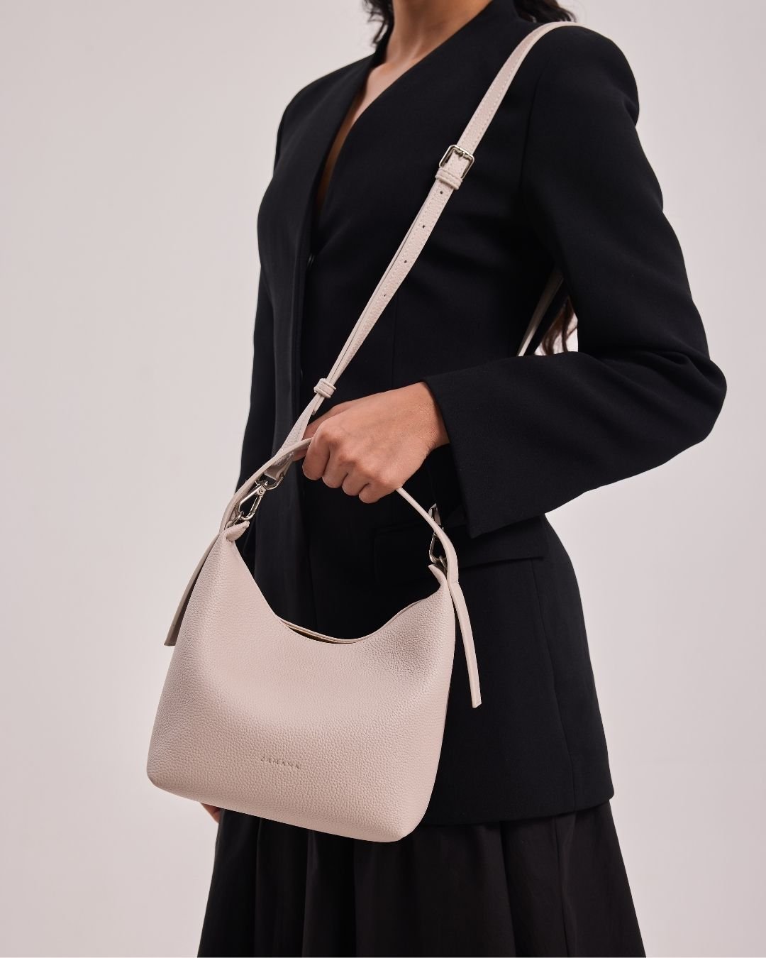 Cream hobo shoulder bag with top handle and long adjustable crossbody strap