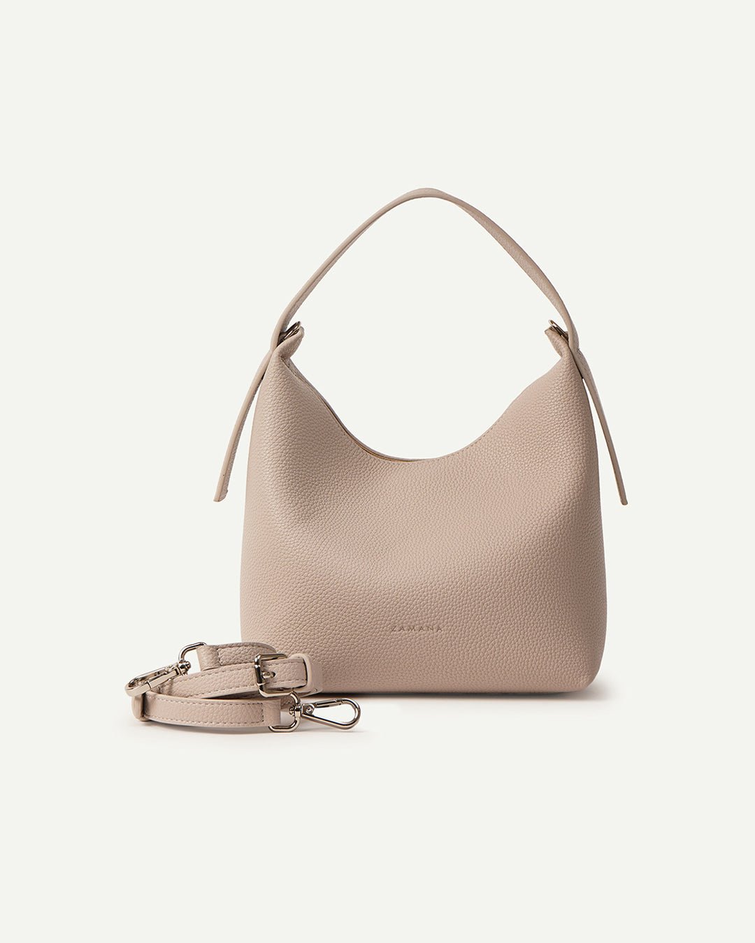 Cream hobo bag with adjustable strap and metal clasp, shown in side view