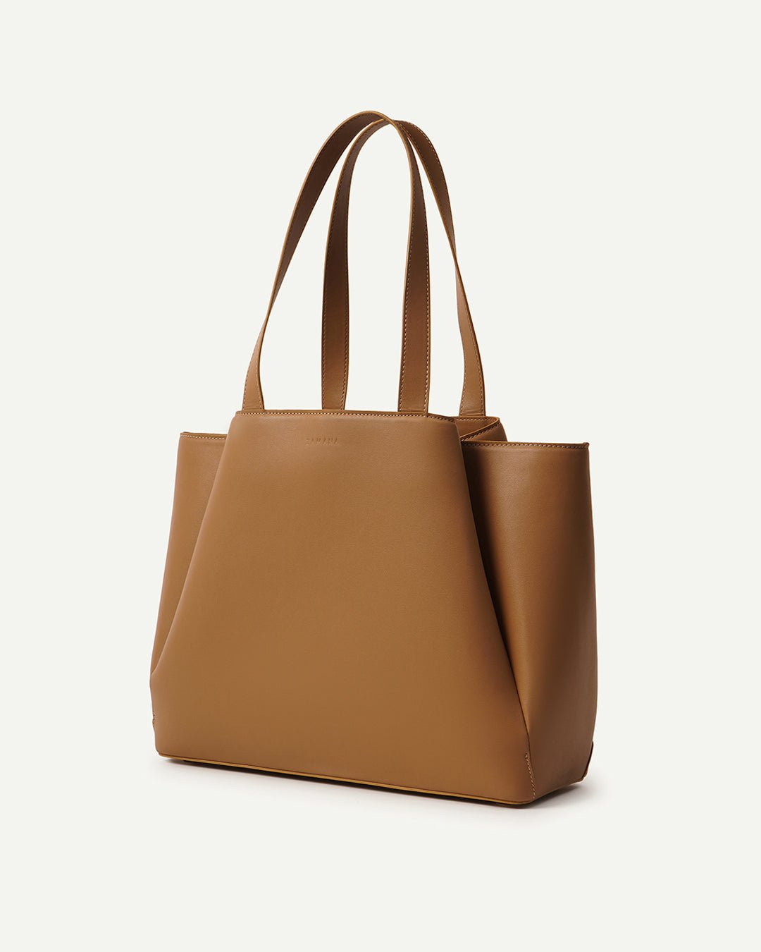 THE MASHKA caramel tote bag angled view with wide straps and solid front panel