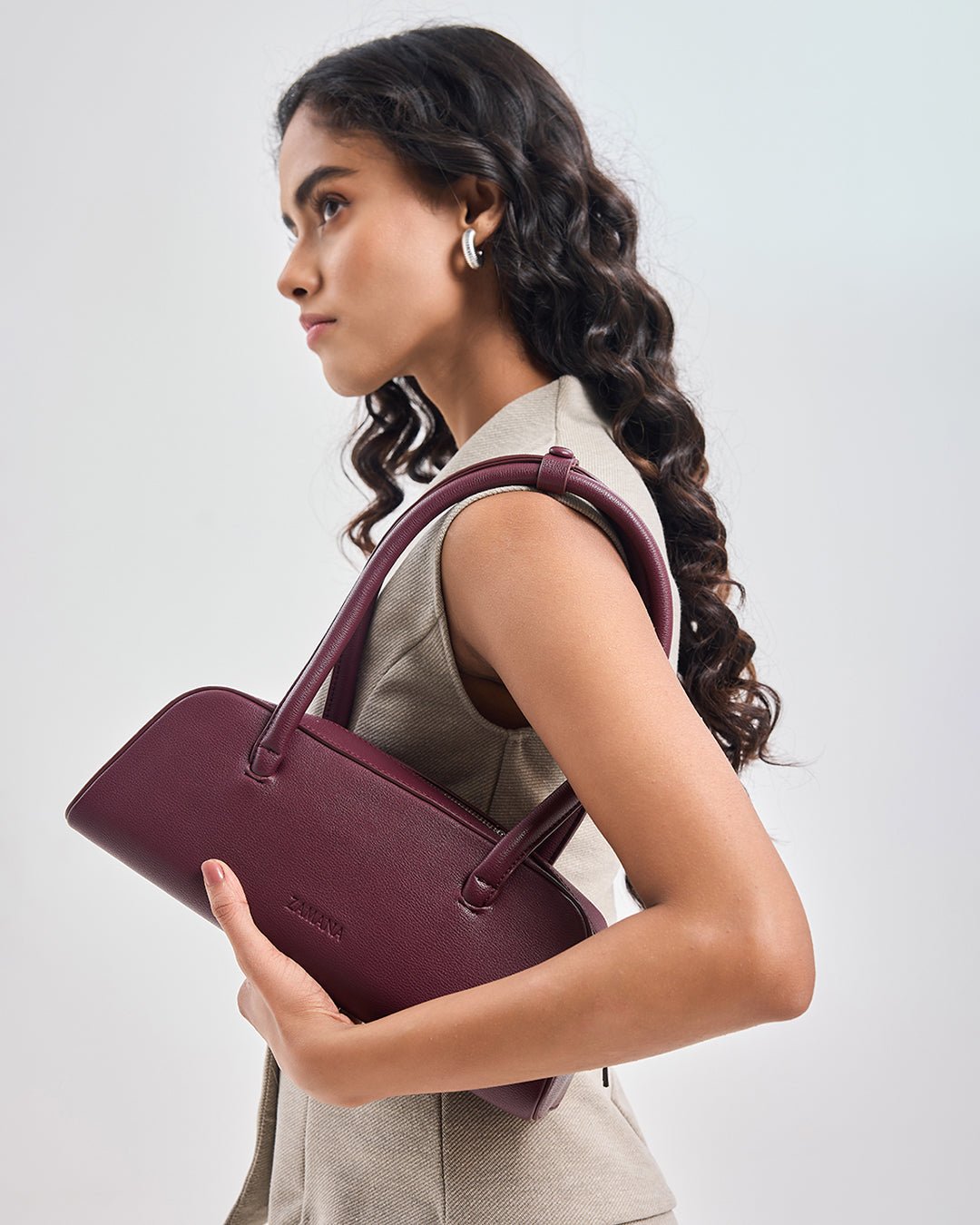 Burgundy leather-look tote handbag with top handles and small front logo