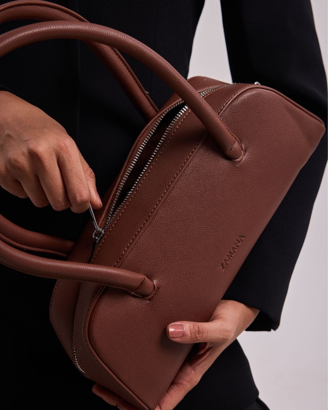 Chocolate brown top-handle handbag with front logo and zip closure