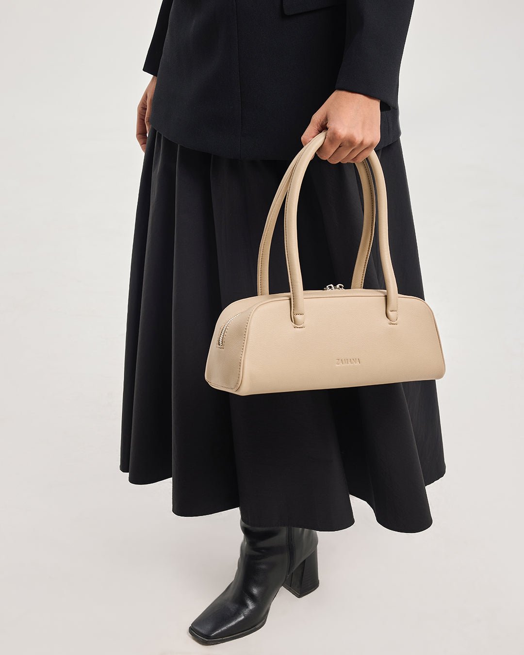 Cream handbag with short top handles and structured shape