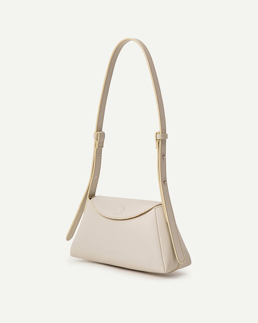 White mini handbag with top handles, slim zipper, and curved front clasp panel.
