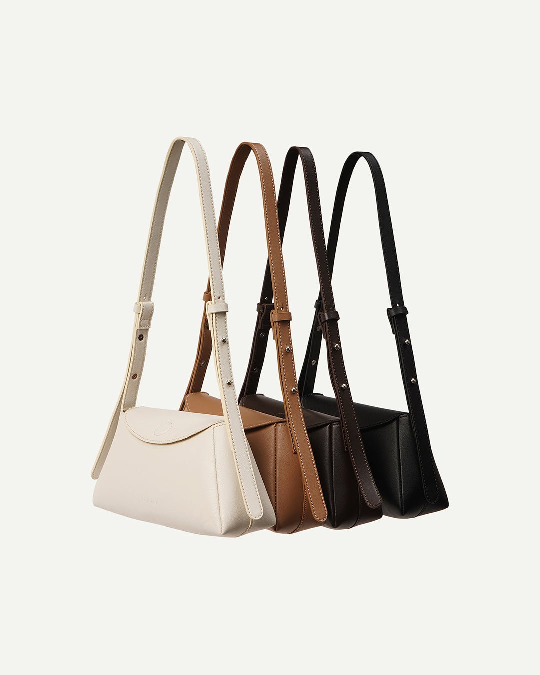 Set of mini handbags with top handles in cream, tan, and brown tones, rope straps.
