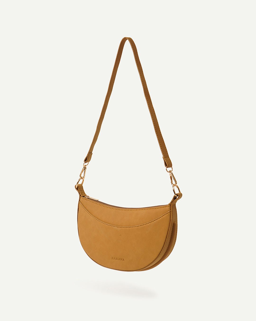 Caramel crescent crossbody bag front view with adjustable strap and gold-tone hardware