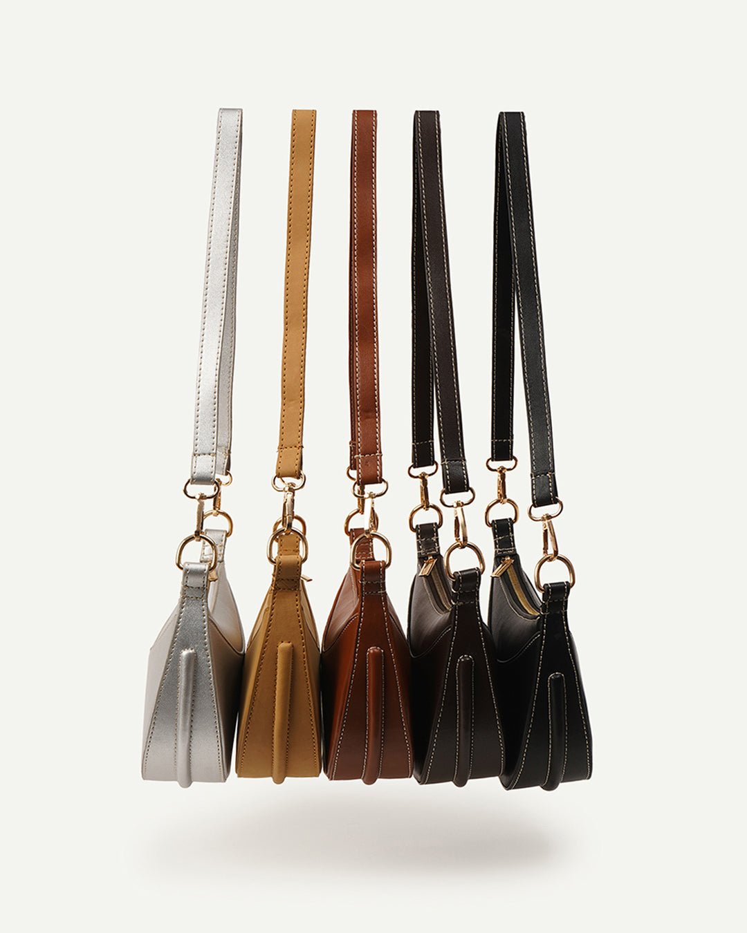 Collection of mini crescent crossbody bags with gold-tone chain straps in assorted colors