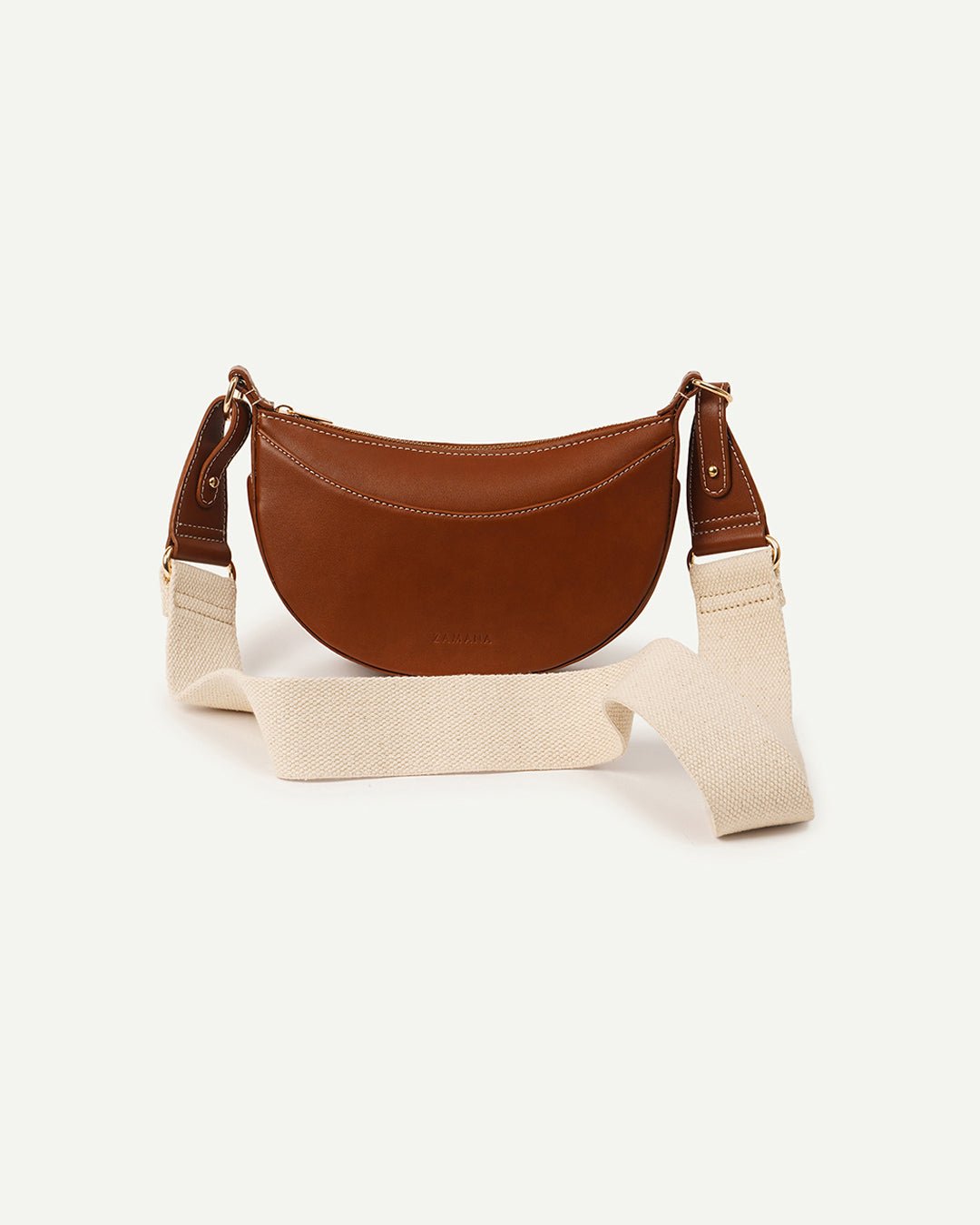 Tan half-moon crossbody bag with chain strap and brown trim