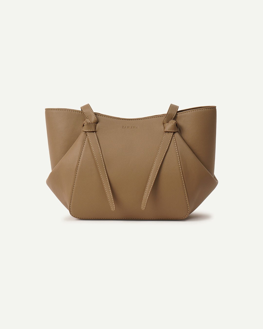 Beige tote bag with two side tassels and structured top