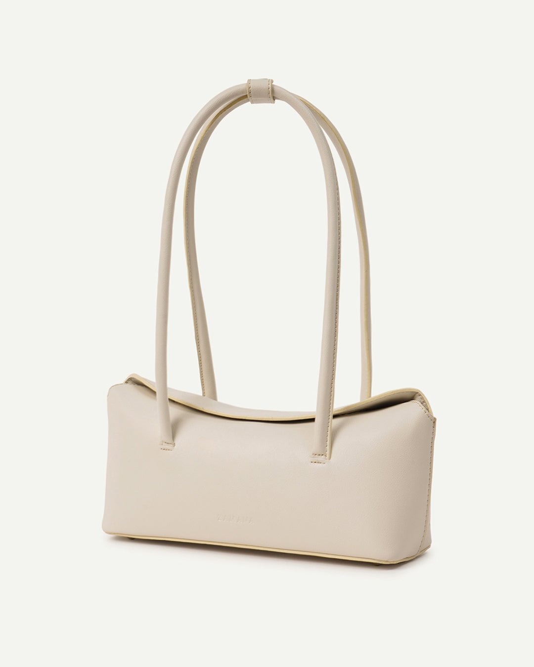 Cream mini tote bag with tall handles, structured sides, and subtle branding