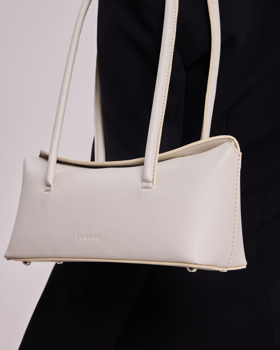 Cream structured tote bag with double top handles and thin edge trim