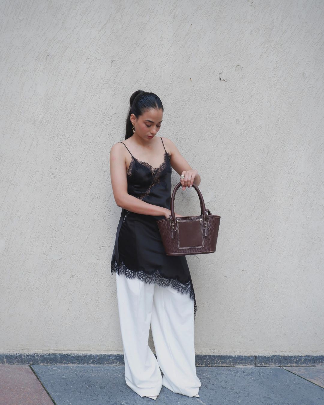 Brown woven shoulder tote bag with short handles and front pocket panel