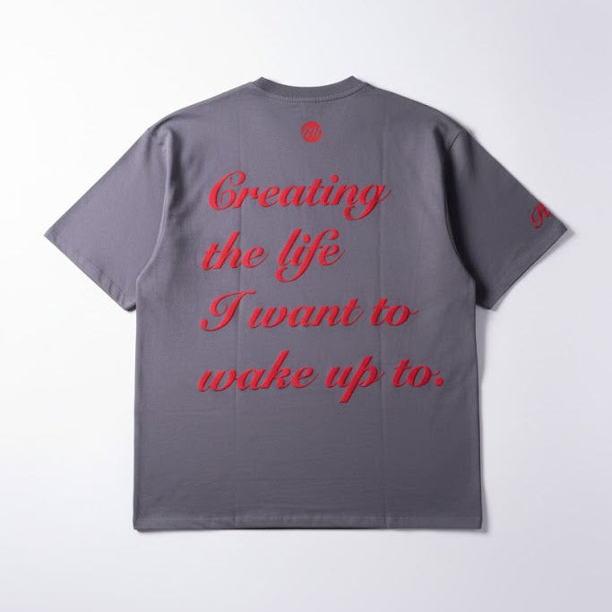Dark gray T-shirt with red script text on back and small logo near neck