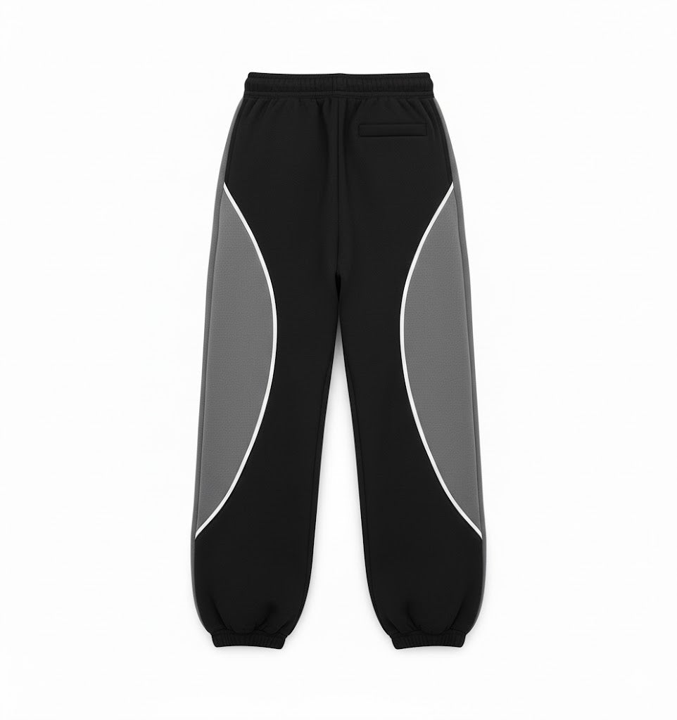 Black and gray panel sweatpants with elastic waistband and relaxed baggy fit