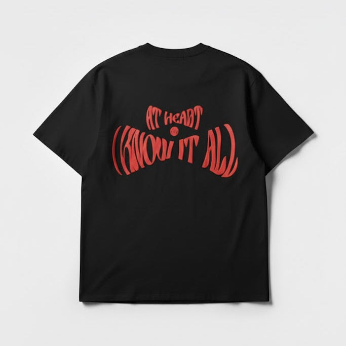 Black crewneck T-shirt with large red typographic graphic and center dot.