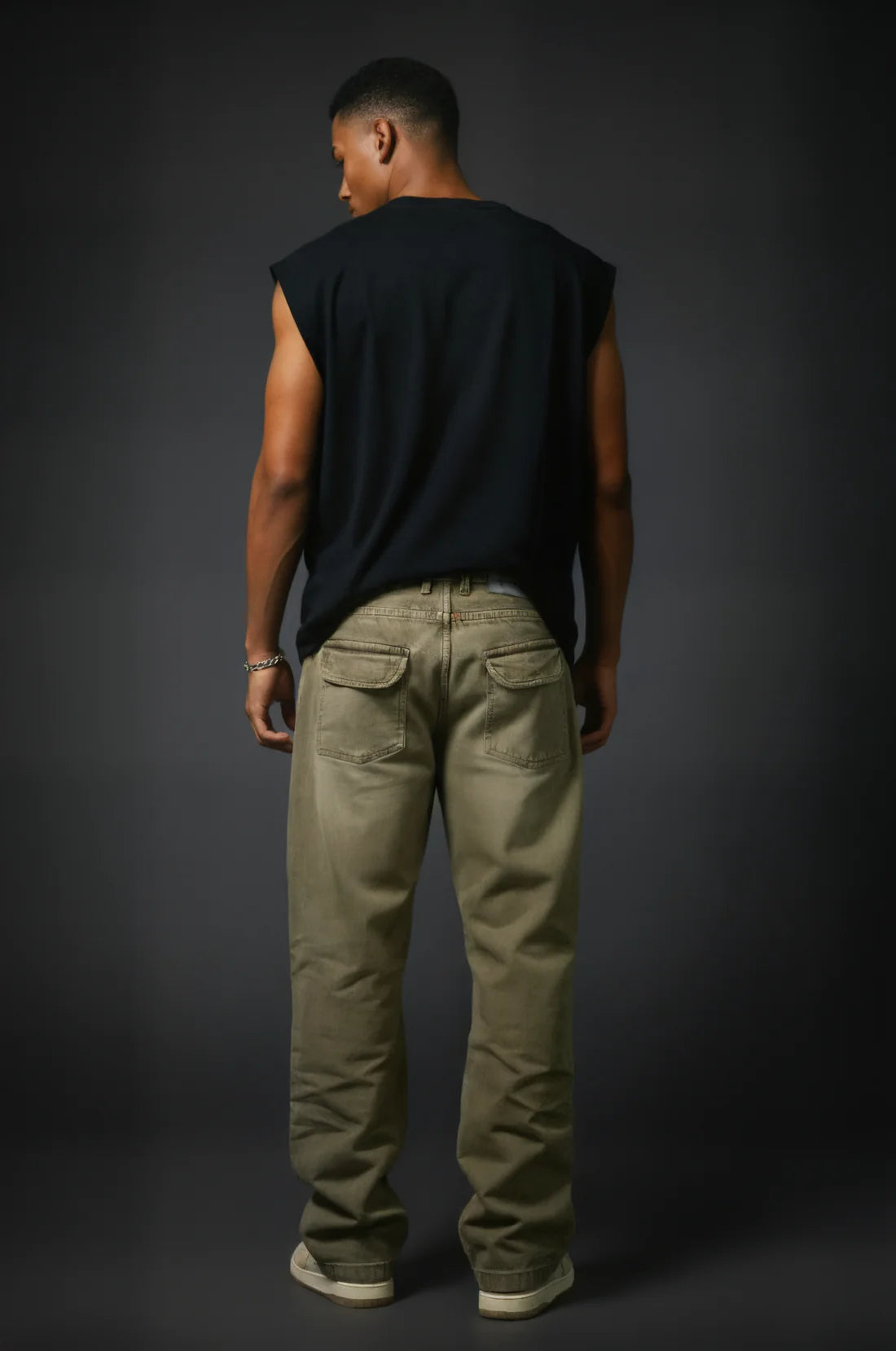 Sand-wash olive baggy denim jeans shown from behind with belt loops and torn knees.