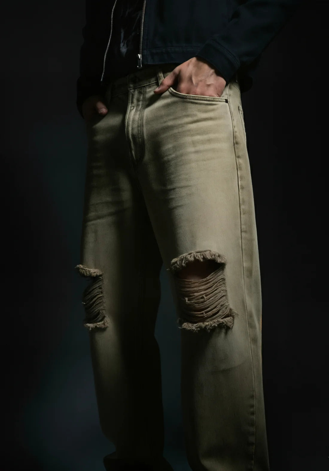 Sand-wash olive baggy denim jeans with distressed knee rips and frayed cuffs.