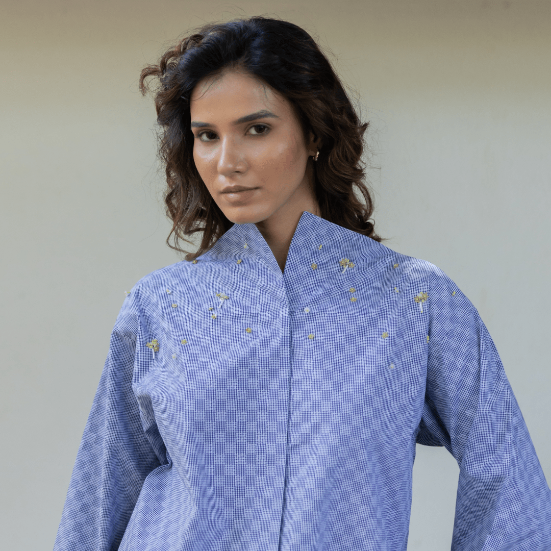Light blue check blouse with button front, standing collar, long sleeves, small yellow floral motifs