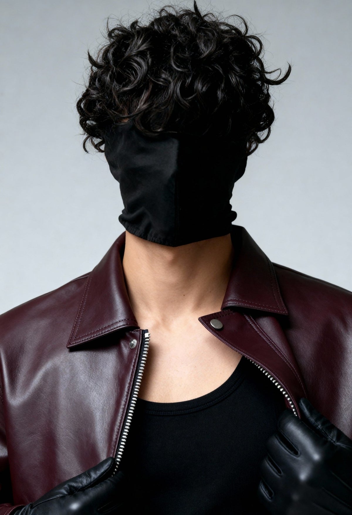 Burgundy leather bomber jacket with stand collar and zip front detail at neckline.