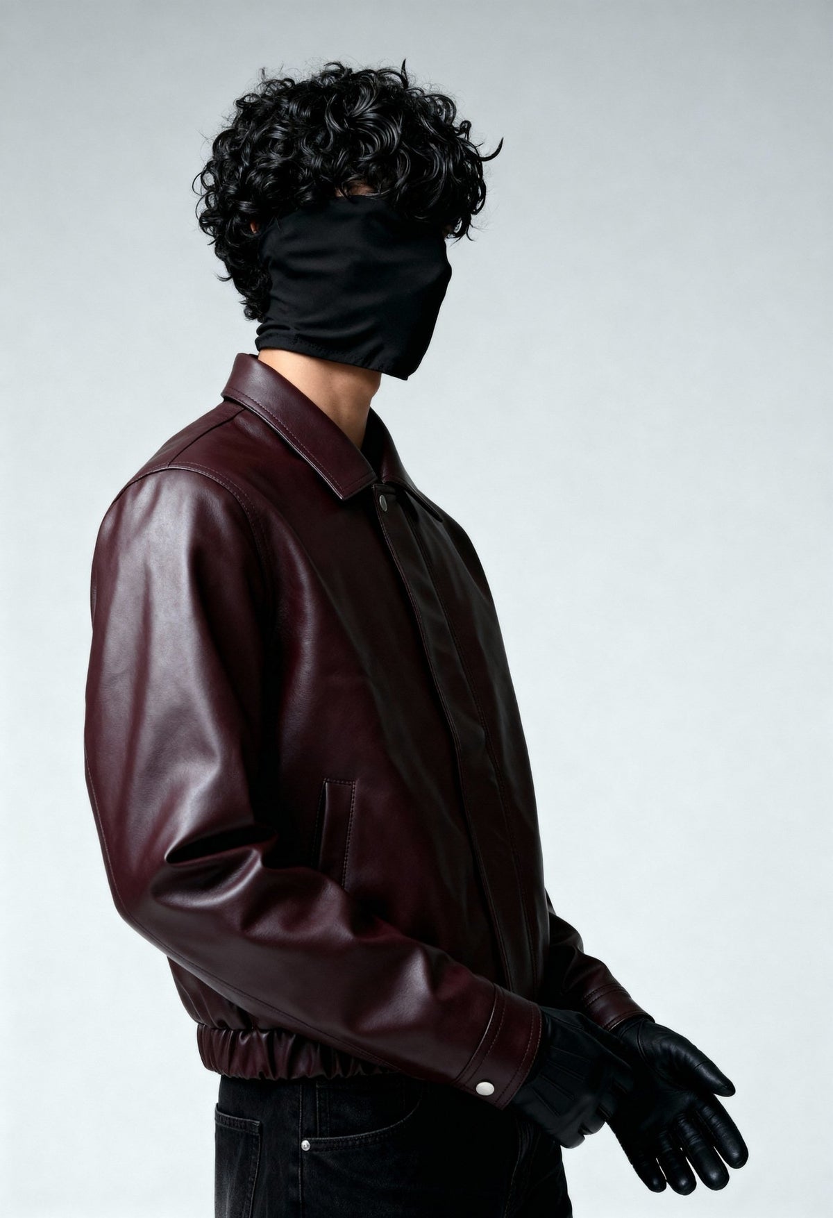 Burgundy leather bomber jacket three-quarter view with snap-tab collar and cuff.