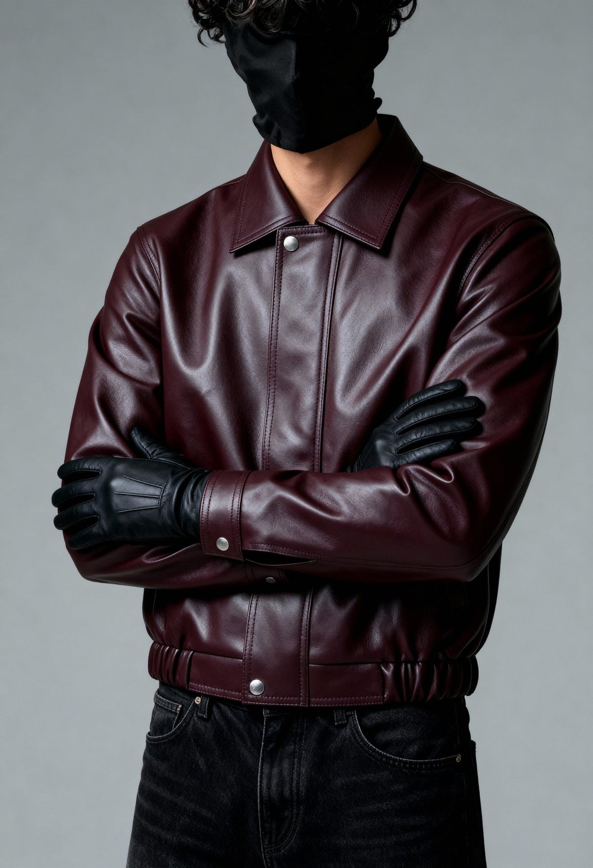 Burgundy leather bomber jacket with stand collar, zipper front, and elastic waistband.