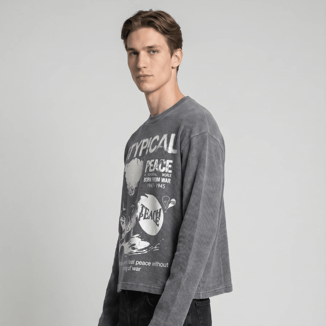 Dark gray waffle-knit long-sleeve sweatshirt with white peace graphic on front, side view