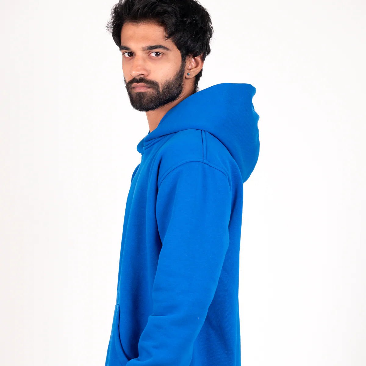 Blue pullover hoodie with adjustable hood and front kangaroo pocket, side view