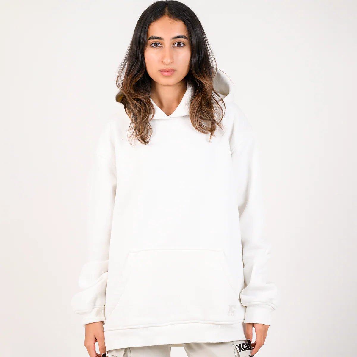 White pullover hoodie with hood and kangaroo pocket, front view on model.